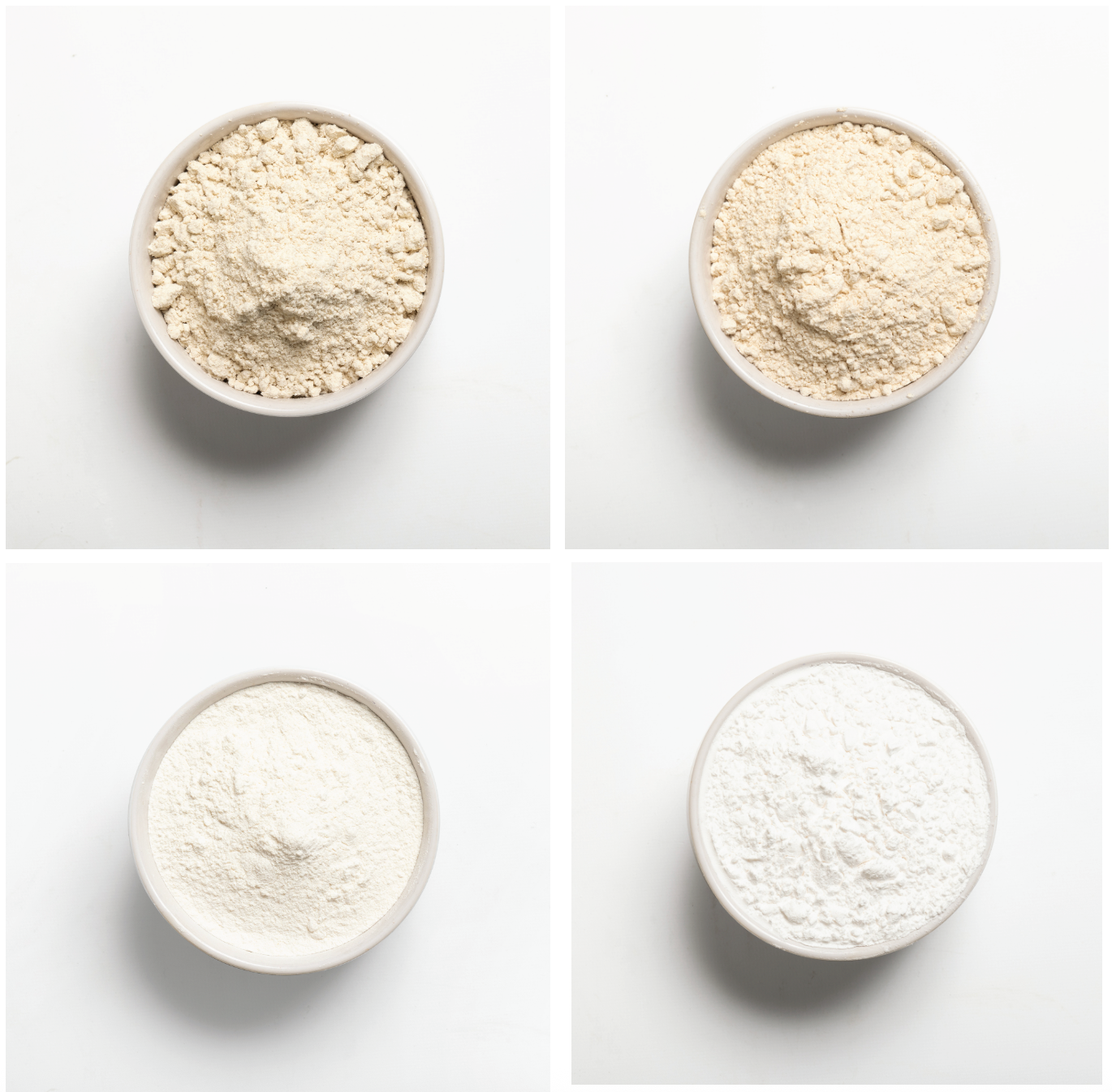 Four bowls of different types of flour on a white background
