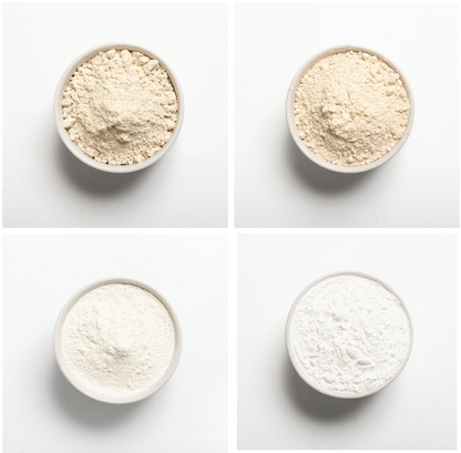 Four bowls of different types of flour on a white background