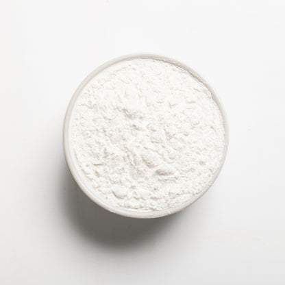a bowl filled with RHBulk Arrowroot Powder on a white background 
