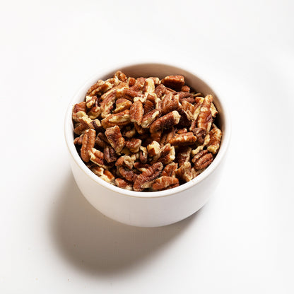 A bowl filled with chopped pecans, view is at an angle 