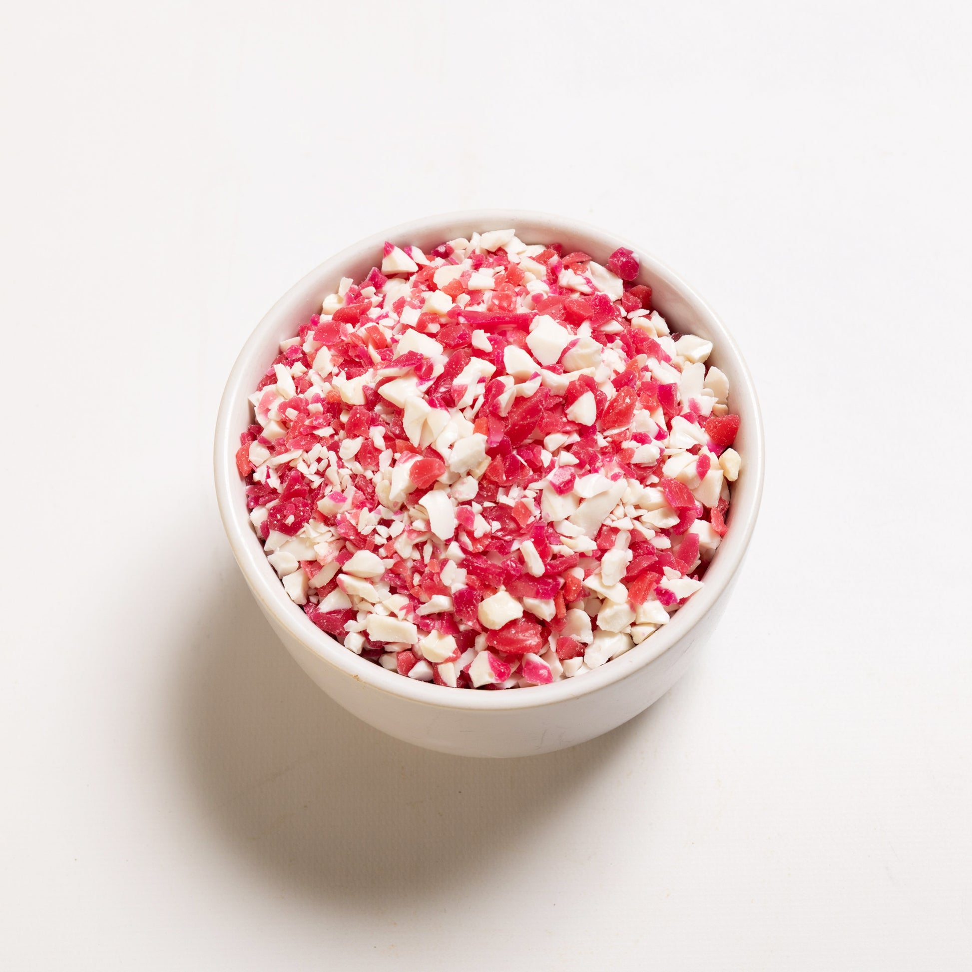 A white bowl filled with crushed peppermint candy from RHBULK 