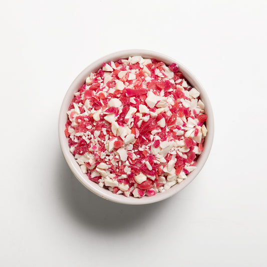 A white bowl filled with crushed peppermint candy 