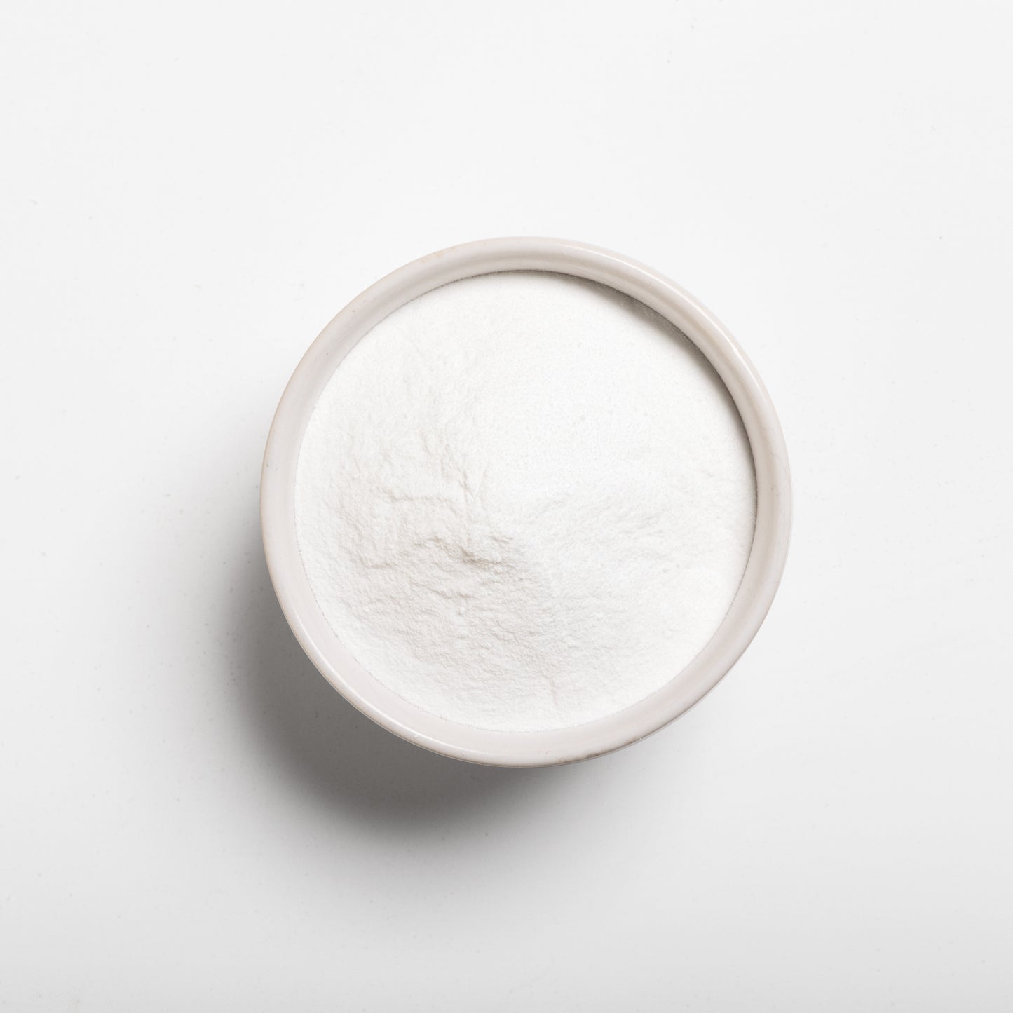 A bowl filled with white dextrose monohydrate powder (corn sugar)