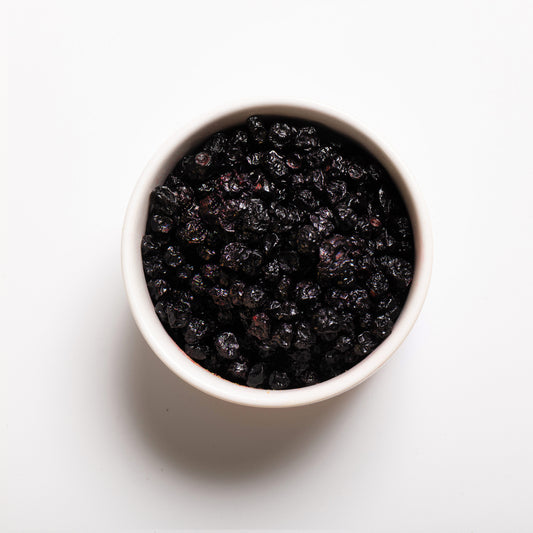 A white bowl filled with Dried Cultivated Blueberries from RHBULK 