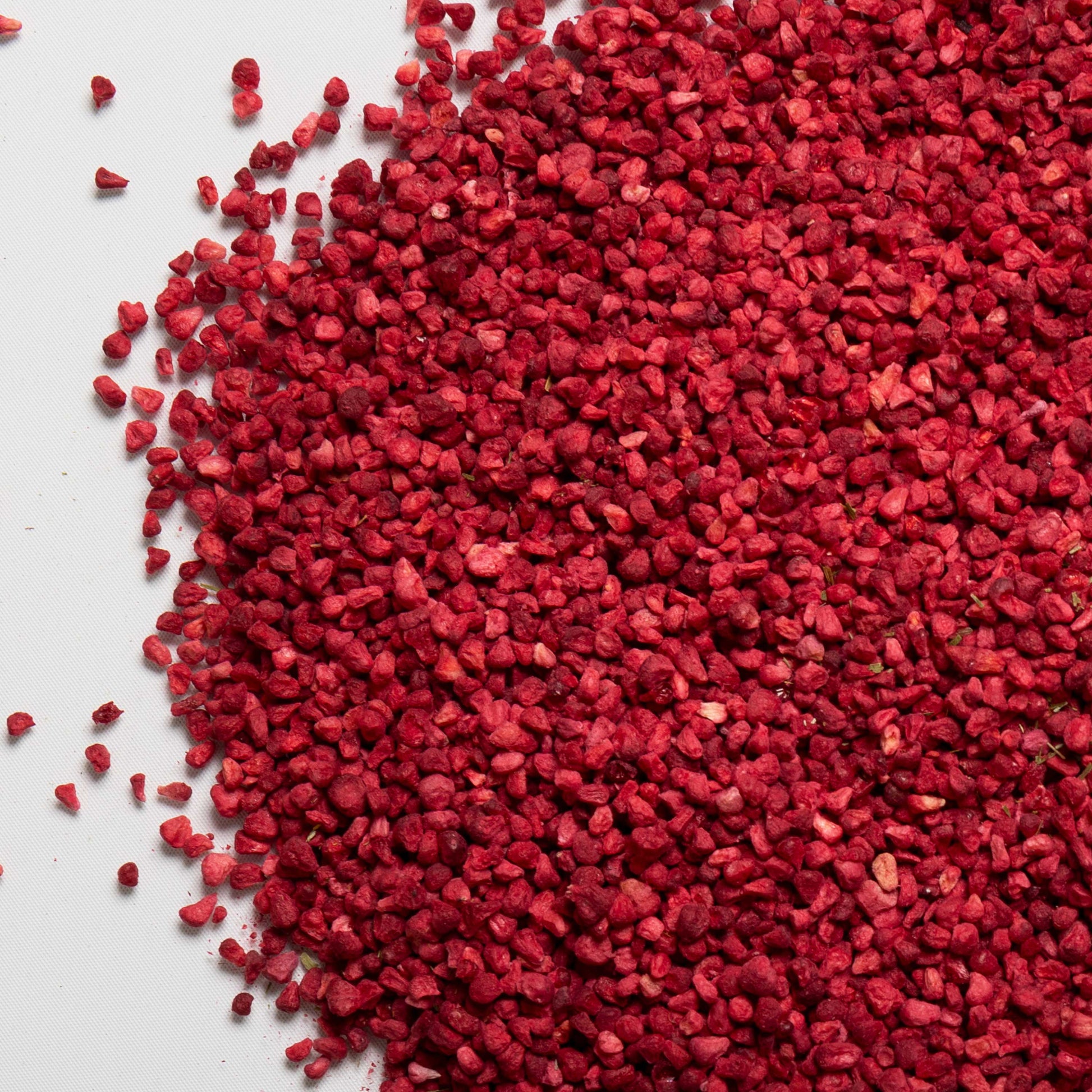 loose product photo of freeze dried raspberry granules showing texture of berries 