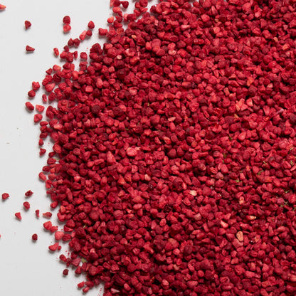 loose product photo of freeze dried raspberry granules showing texture of berries 