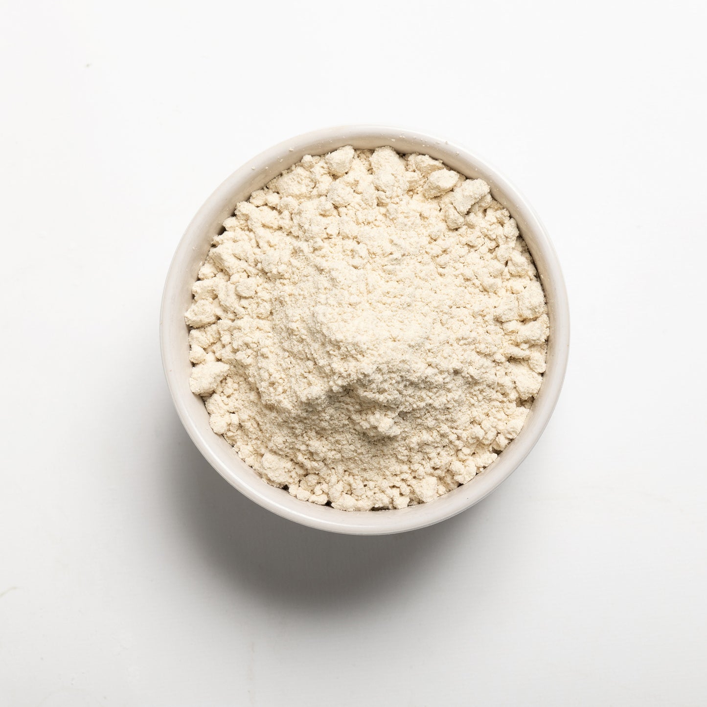 A bowl filled with Sorghum Flour on a white background