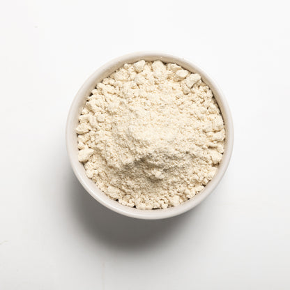 A bowl filled with Sorghum Flour on a white background
