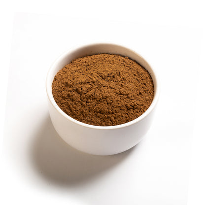 A small white bowl filled with ground cloves on a white background.