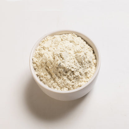 A bowl filled with white powdery substance, representing Guar Gum, on a white background.