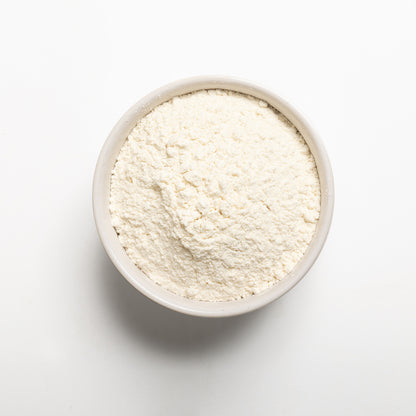White bowl filled with High Gluten bread flour on a white background