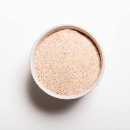 A white bowl filled with Himalayan Pink Salt (finely ground) 