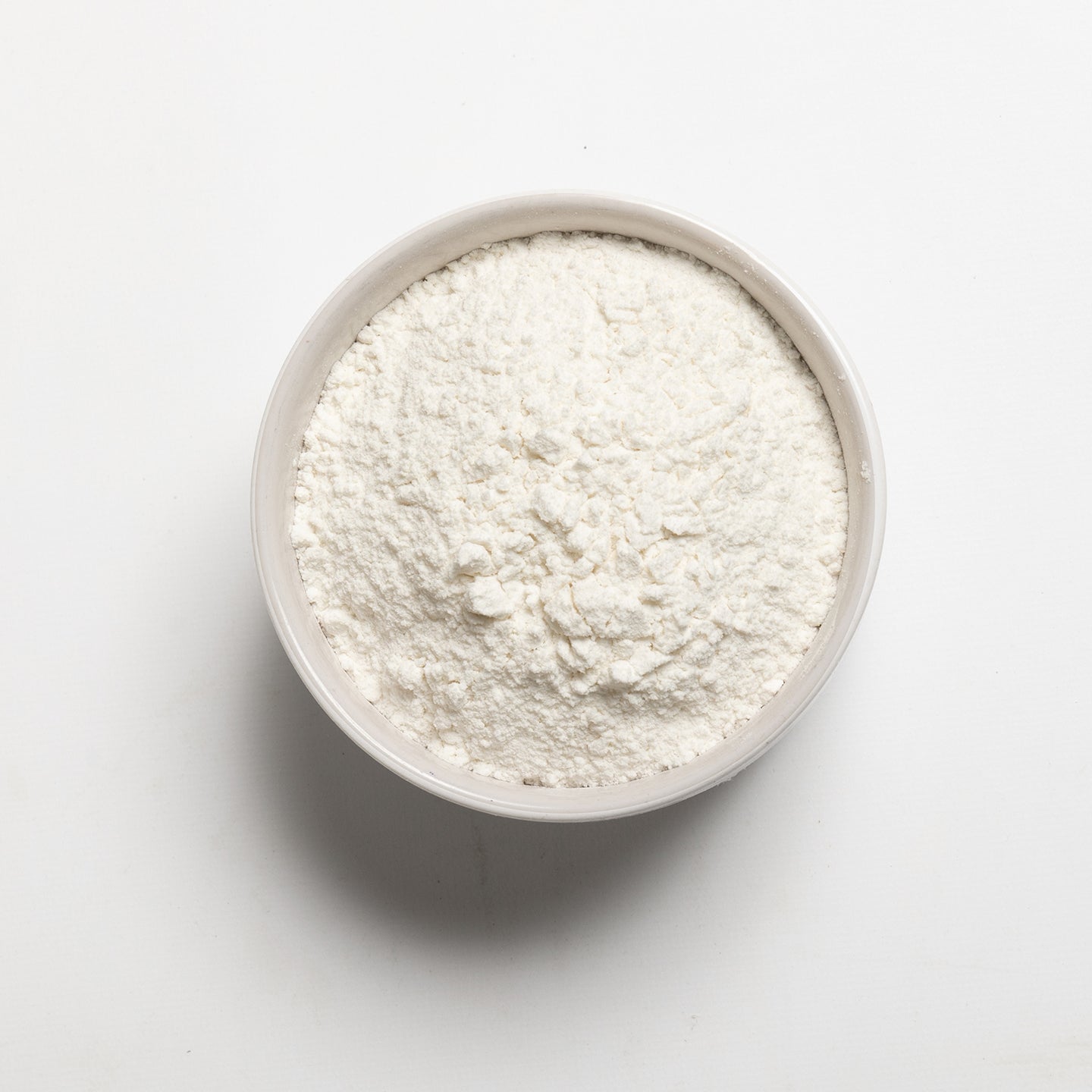 Medium Grain White Rice flour in a bowl on a light gray background