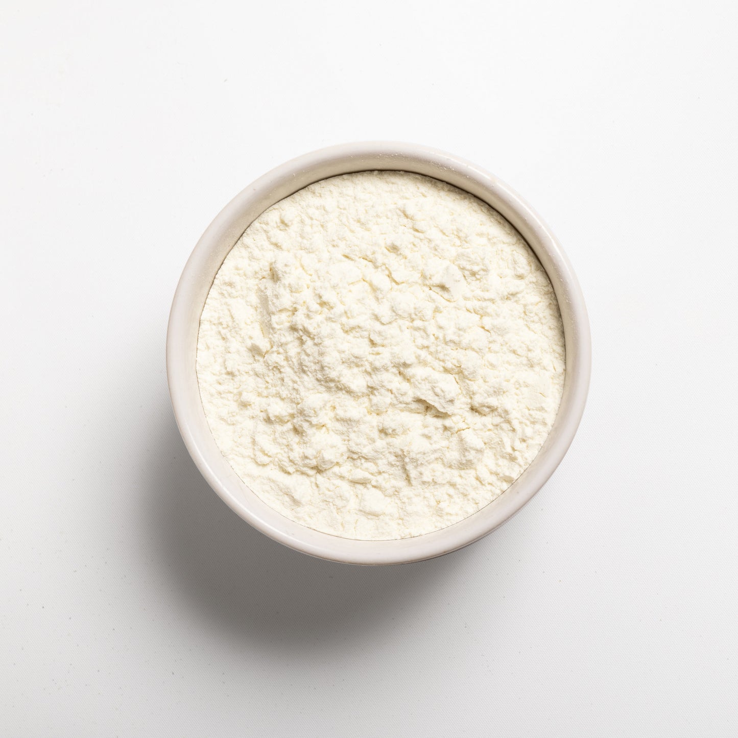 A white bowl filled with milk protein concentrate.