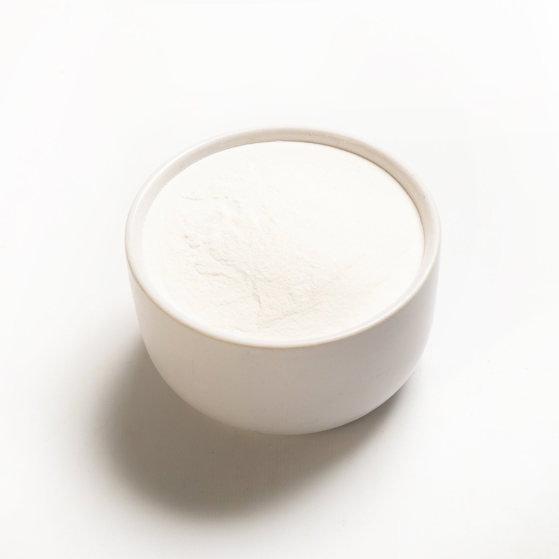 A bowl of white modified tapioca starch on a white background.