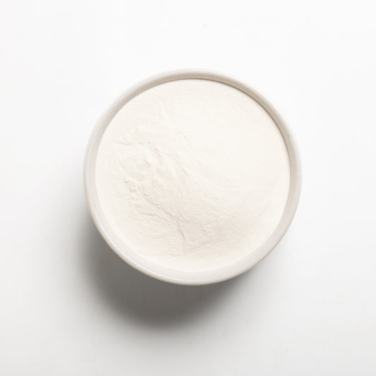 A bowl filled with modified tapioca starch on a light gray background
