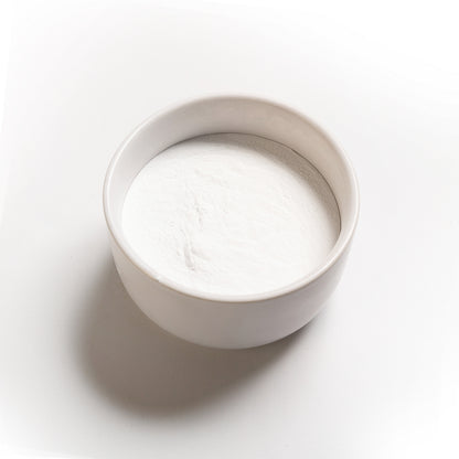A container filled with white powdery substance on a white background, representing Monocalcium Phosphate Anhydrous (V90)
