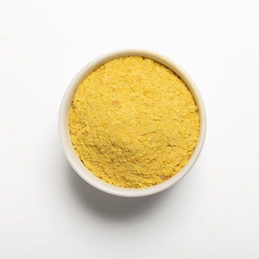 RHBULK nutritional yeast in a white bowl on a light gray background