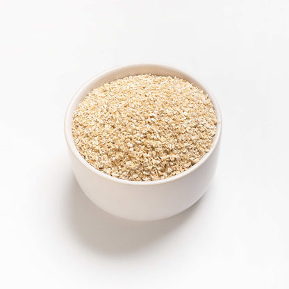 A bowl full of quick cooking steel cut oats (Oat Bran) on a white background.