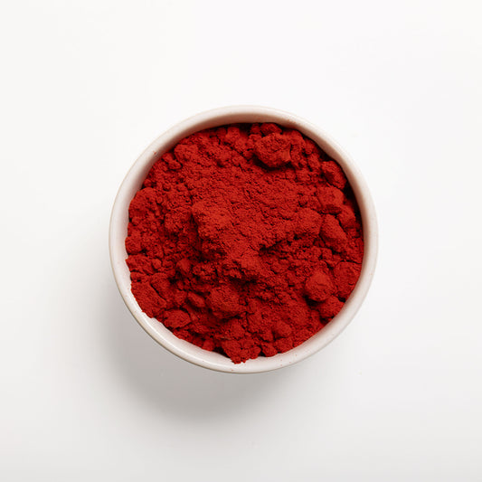 a bowl filled with RHBULK Orange Vegetable Powder on a white background 