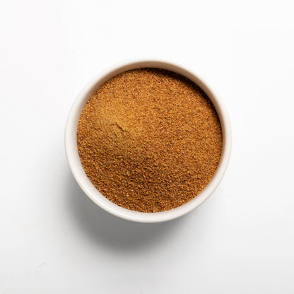 A bowl filled with Organic Coconut Sugar on a white background
