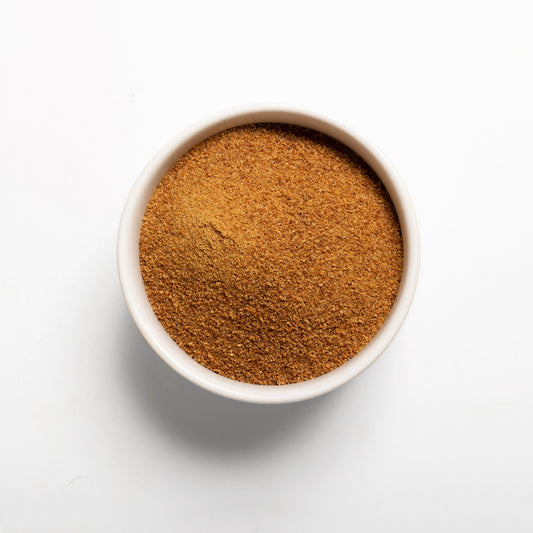 A bowl filled with Organic Coconut Sugar on a white background