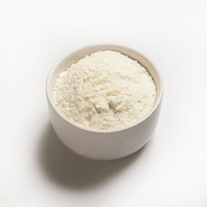 A bowl of organic coconut flour on a white background.