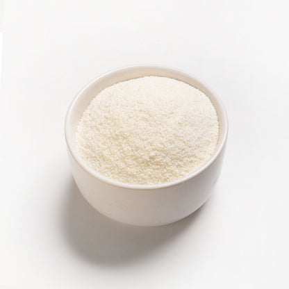 A bowl of Polar White Cornmeal on a white background, showing the fine texture of the cornmeal.
