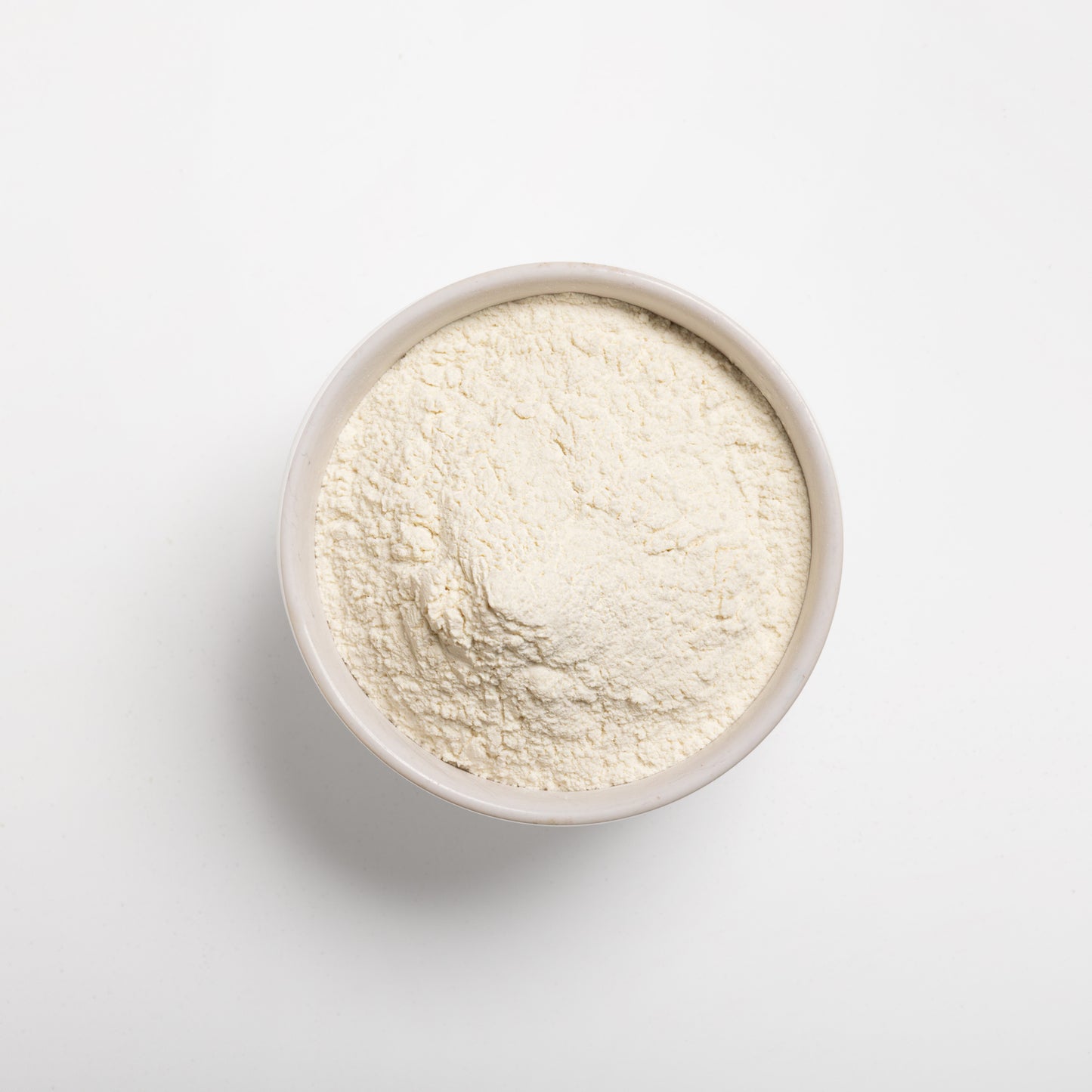 A bowl filled with pre-gelatinized wheat flour on a white background.