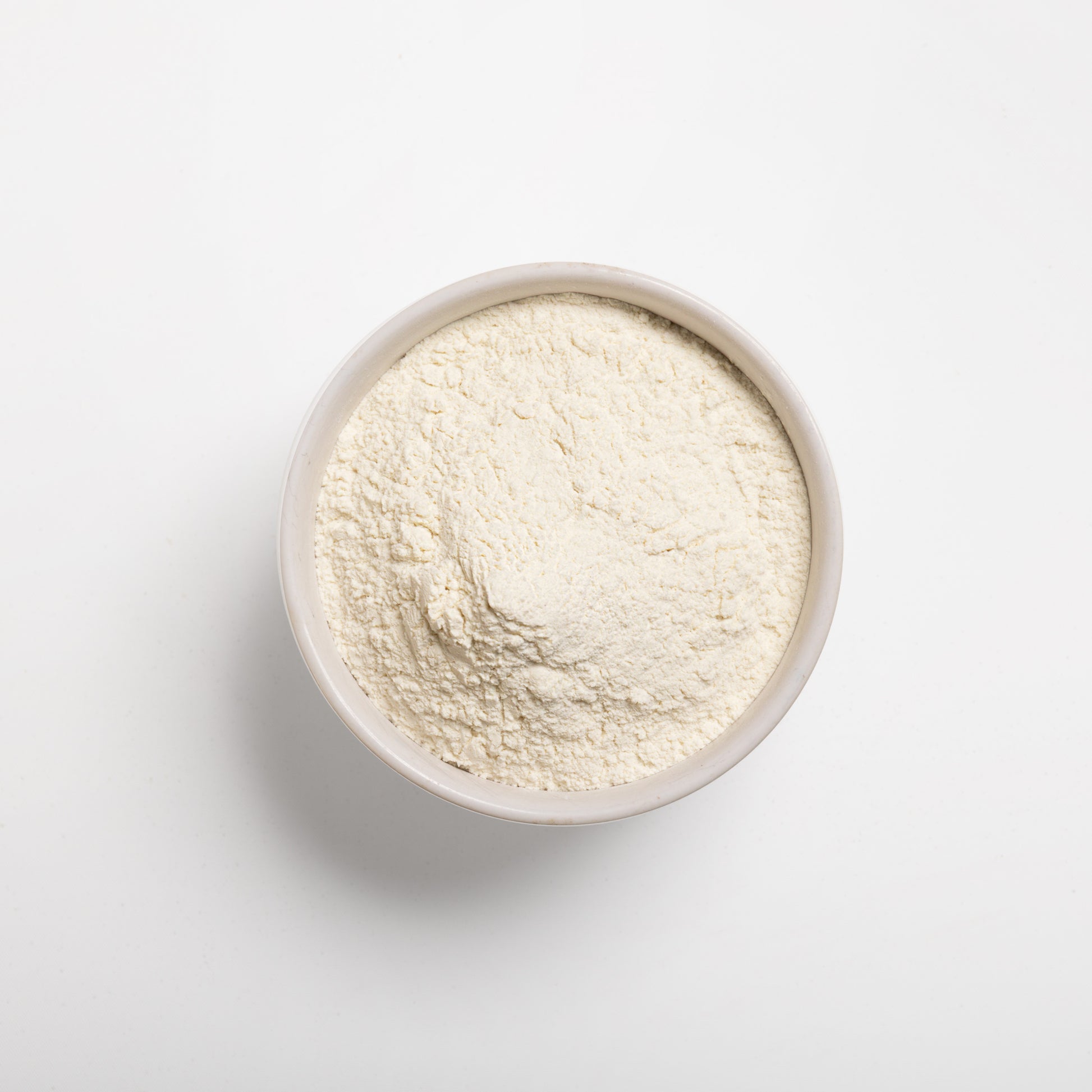 A bowl filled with pre-gelatinized wheat flour on a white background.