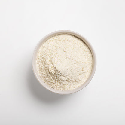 A bowl filled with pre-gelatinized wheat flour on a white background.