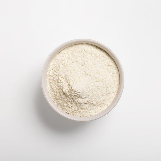 A bowl filled with pre-gelatinized wheat flour on a white background.