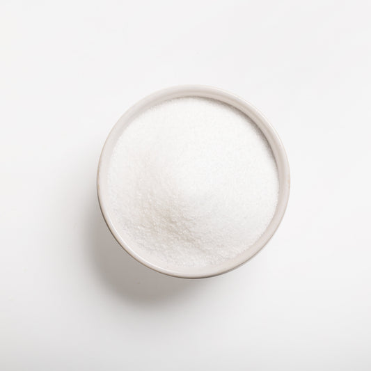 A bowl of purified (untreated) sea salt on a white background.