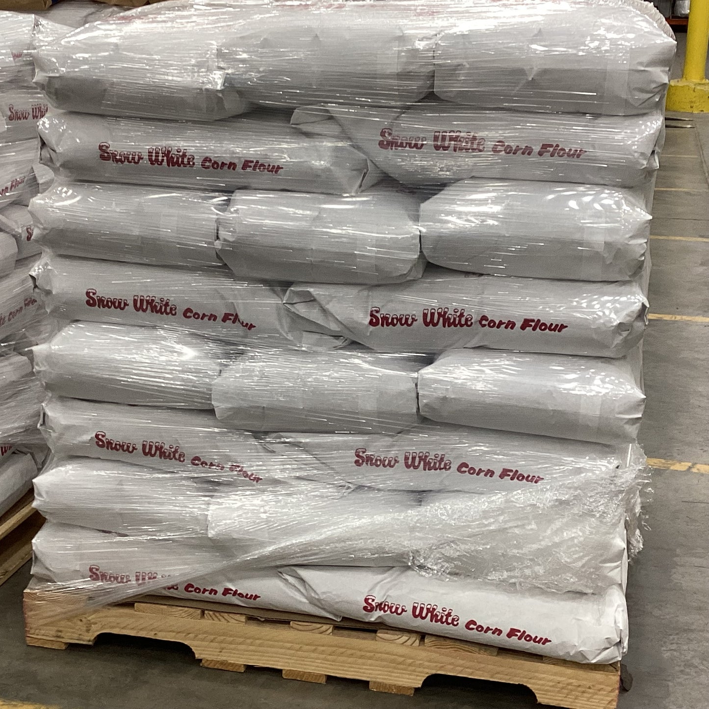Stack of Snow White Corn Flour bags on a pallet