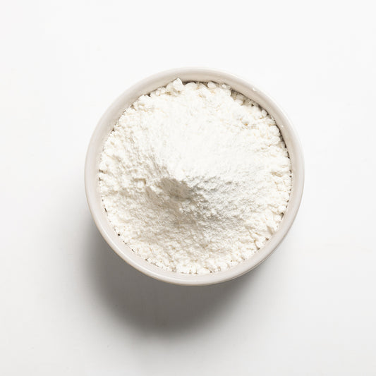 A bowl of white sweet rice flour on a white background.