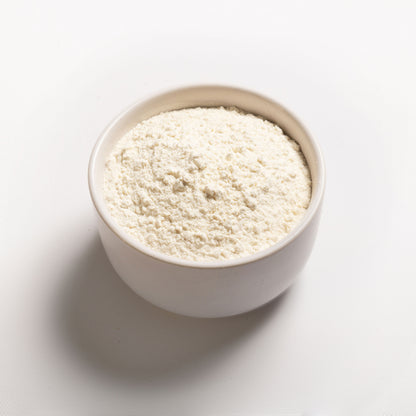 A bowl filled with white flour-like powder on a white background, representing vital wheat gluten.