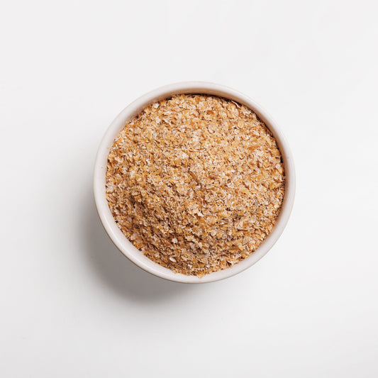 A bowl of wheat bran on a white background.