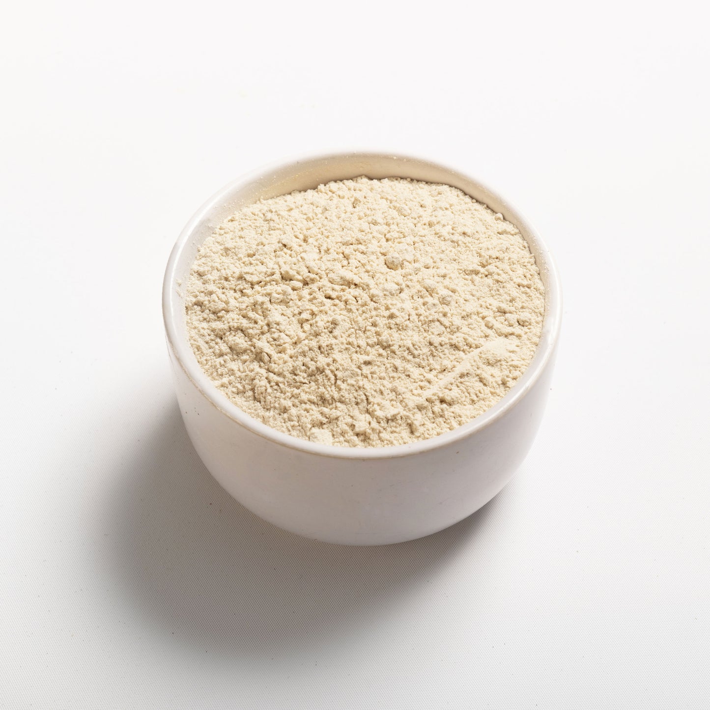 Wheat Protein Isolate in a white bowl at an angle view 