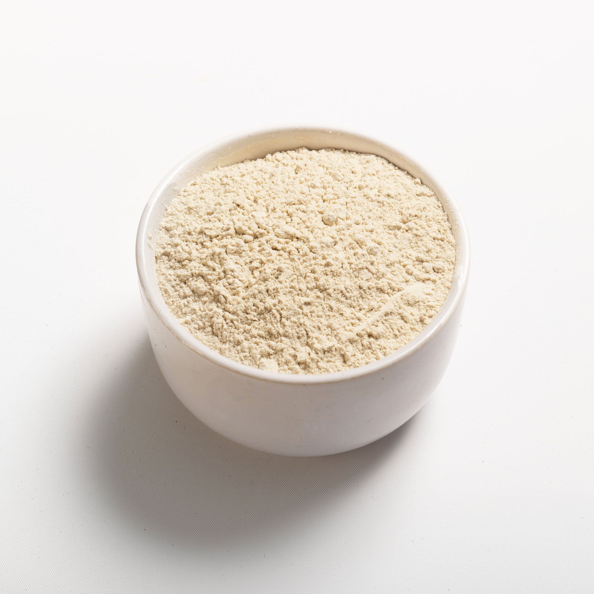 Wheat Protein Isolate in a white bowl at an angle view 