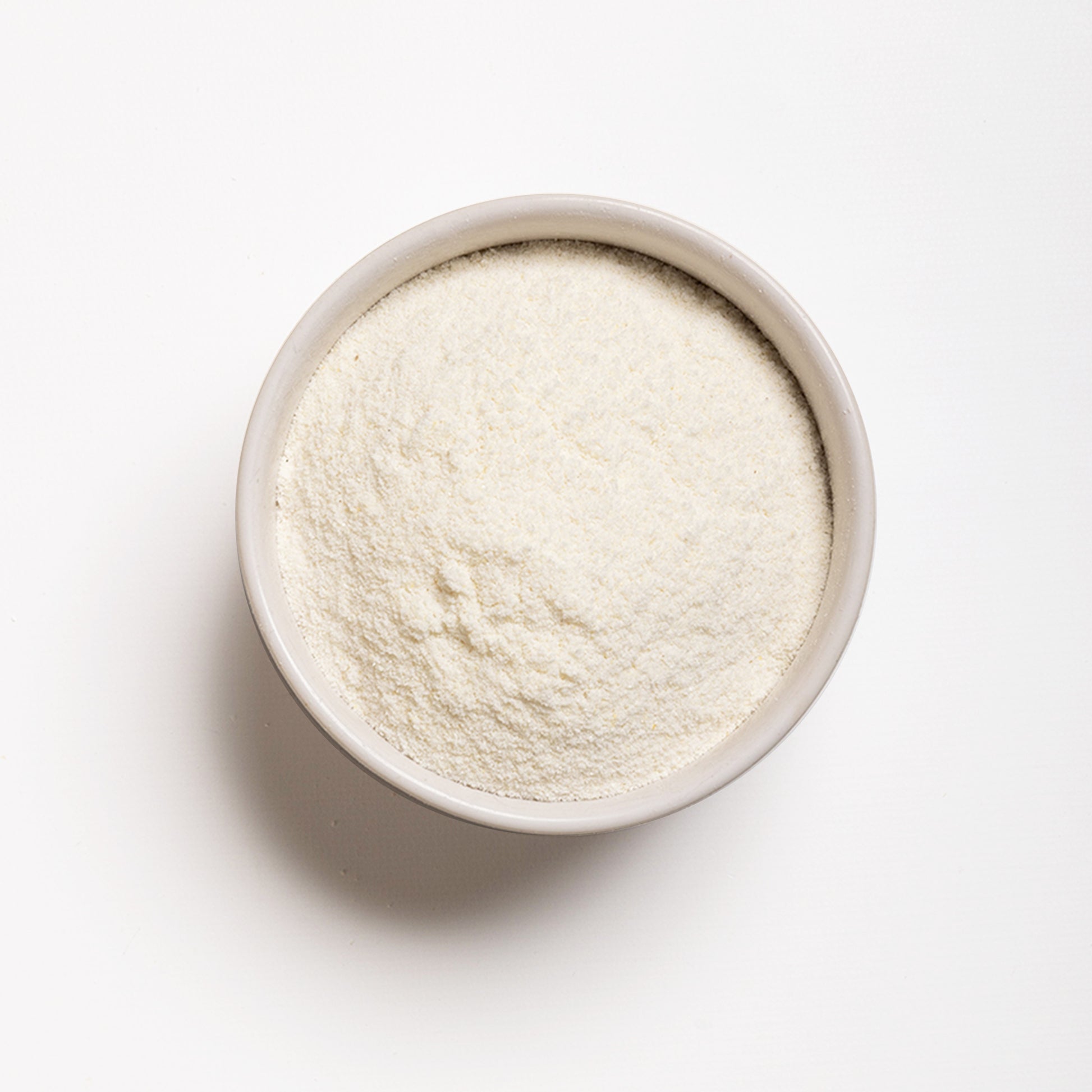 A bowl filled with white arepa flour, which is finely milled cornmeal.