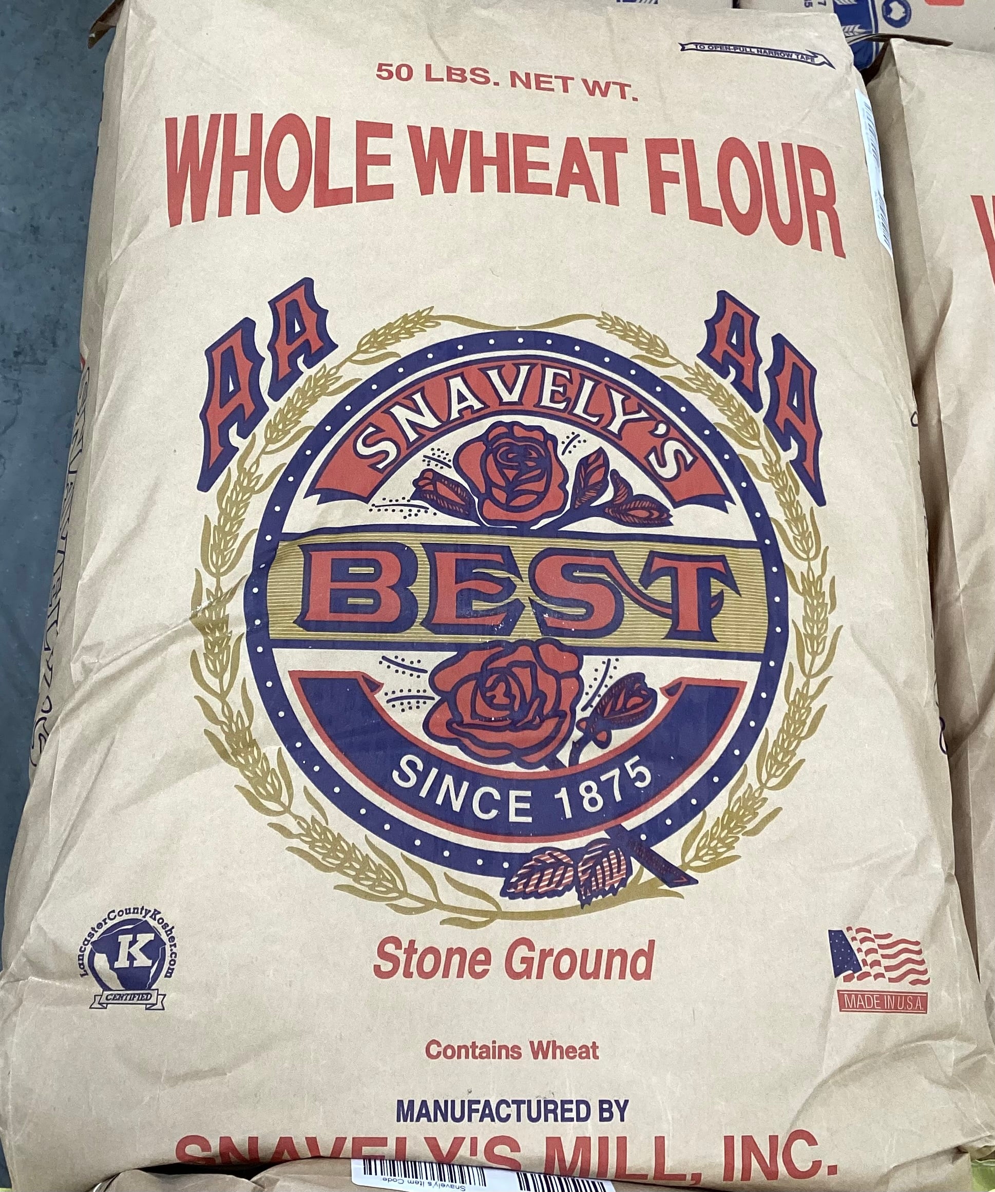 Bag of Snavely's Best whole wheat flour with branding and product details.