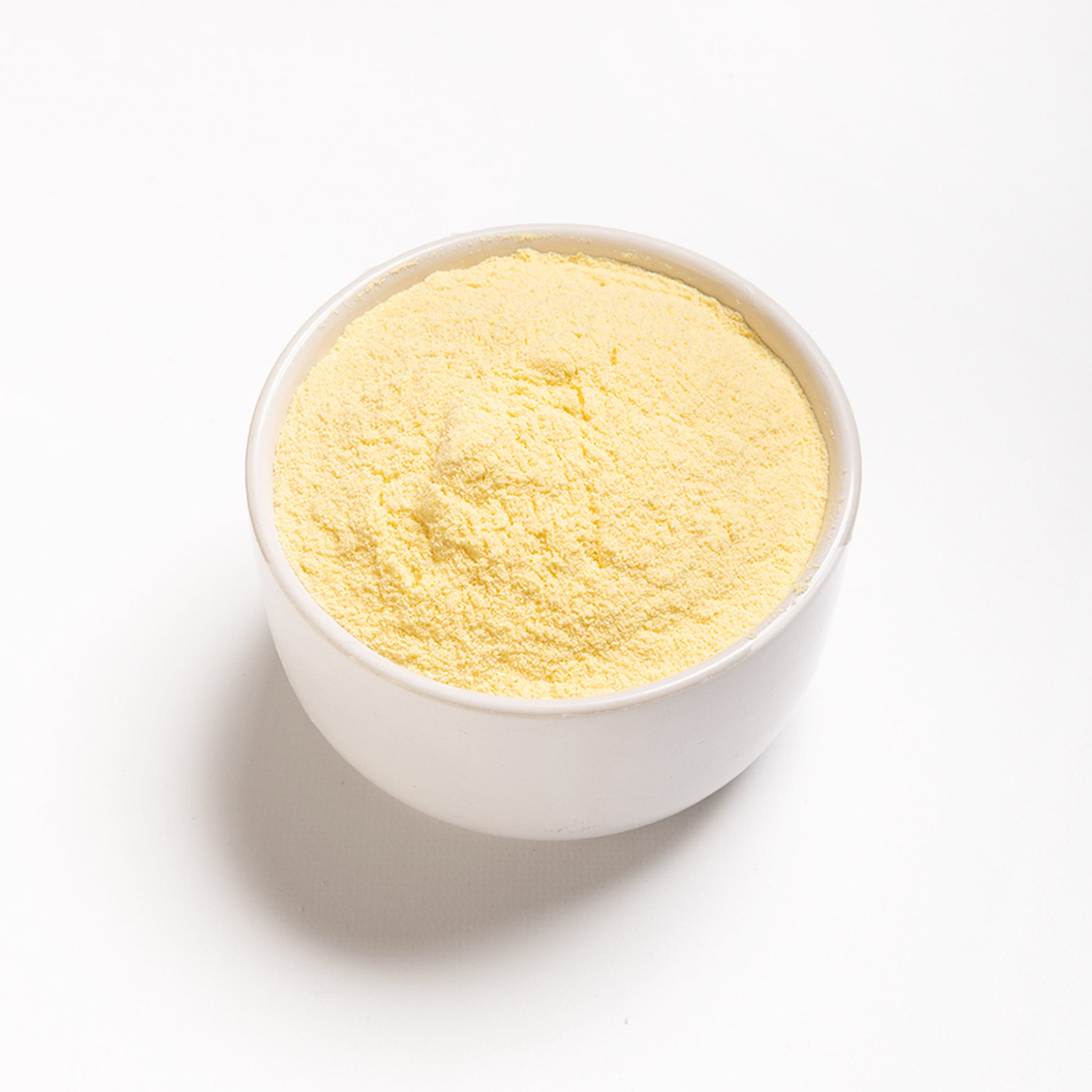 Yellow Arepa Flour in a white bowl (precooked yellow flour)