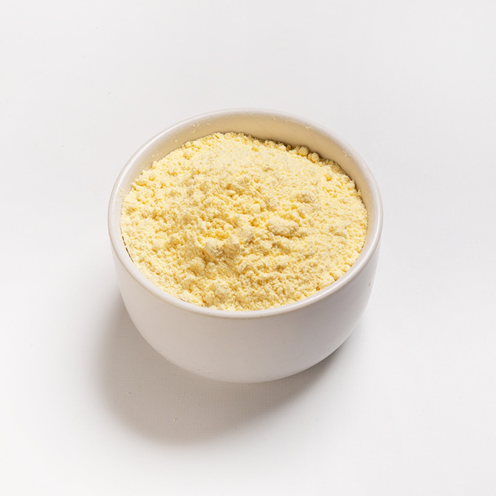 White Bowl filled with Yellow Corn Flour - angle view