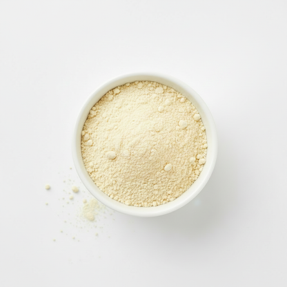 White bowl filled with butter powder on a white background