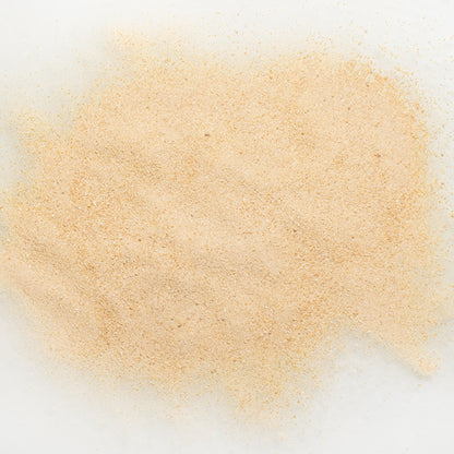 Close-up of maple flavor powder on a white background
